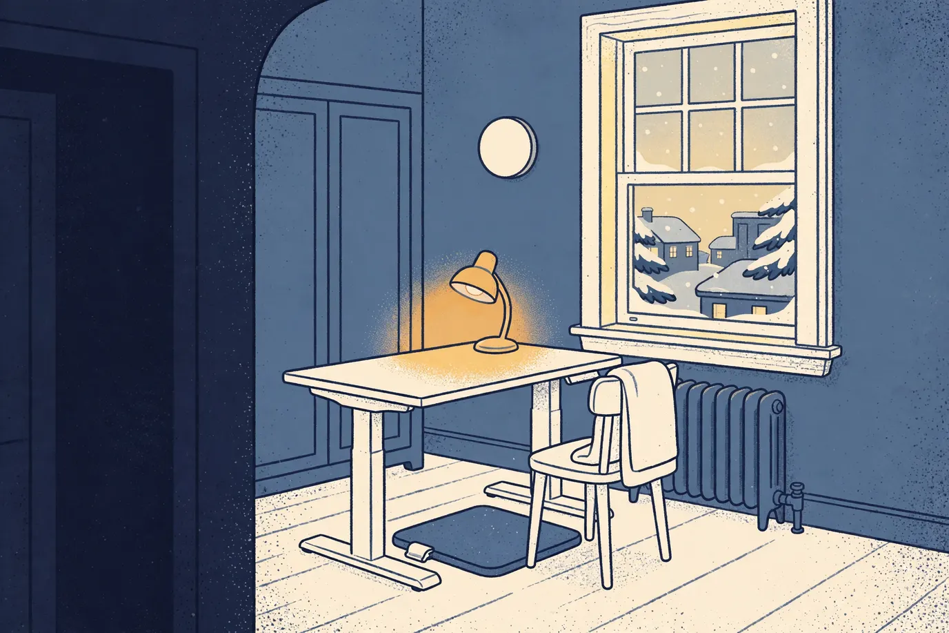 Upstairs home office at night with a standing desk, a low walking pad under it, a glowing desk lamp and snow outside the window.